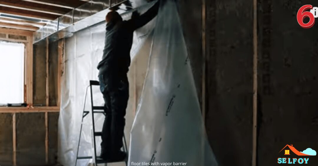 Man is installing polythene sheet vapor barrier over a big wall