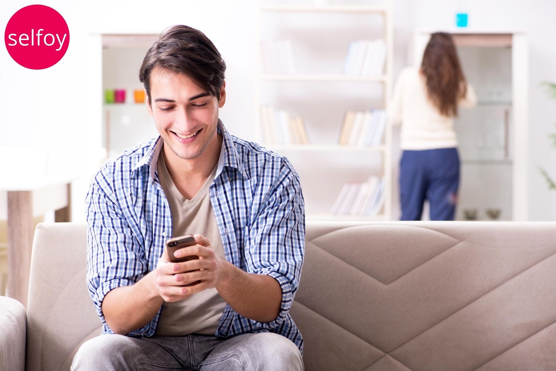 Man is holding mobile and smiling