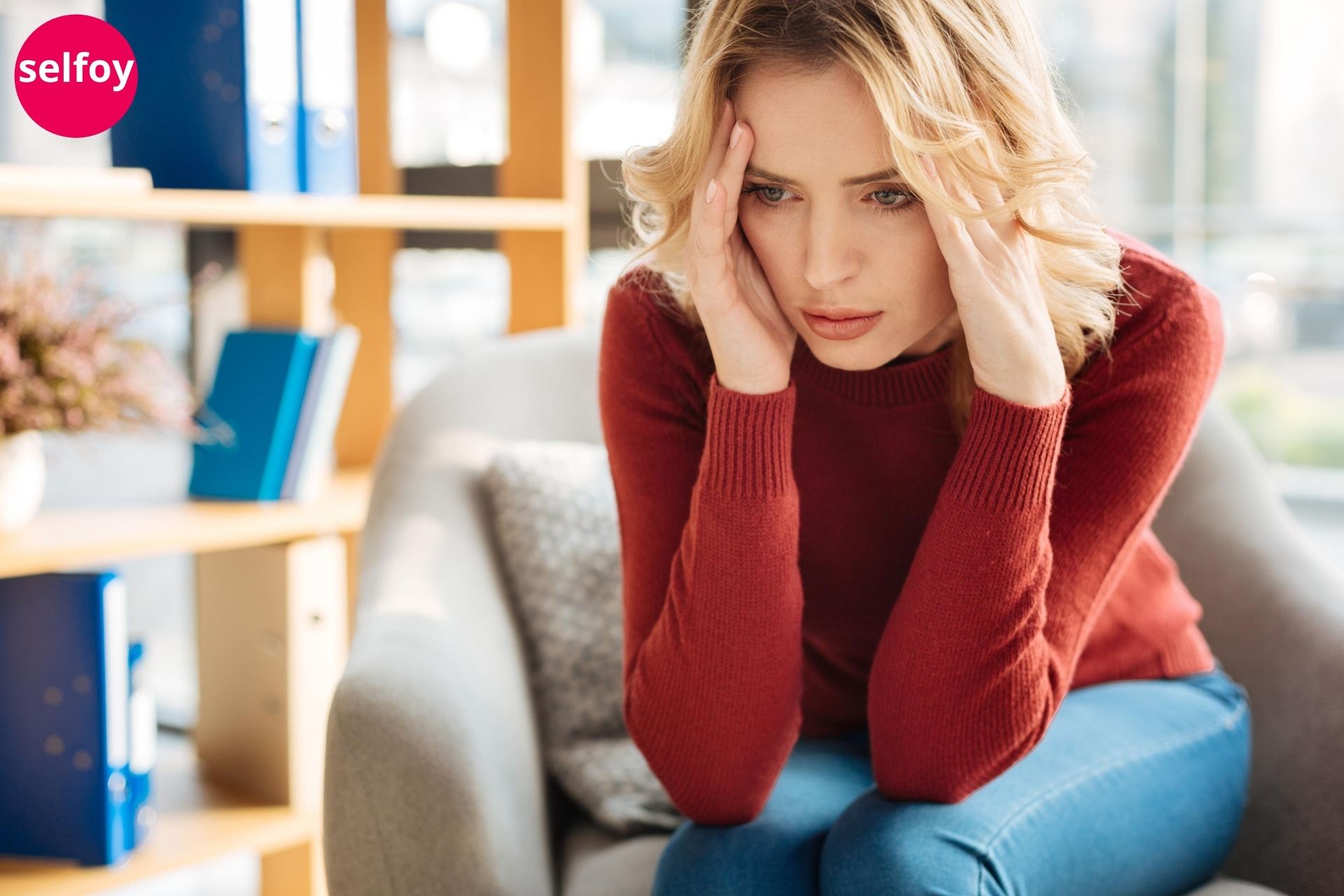 Woman wearing red top having distressed posture