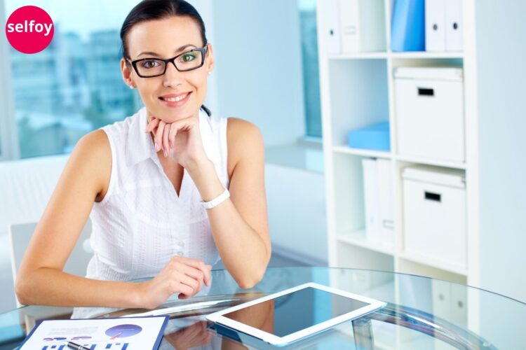 Woman wearing black opticals smiling confident and exhibiting her emotional wellness