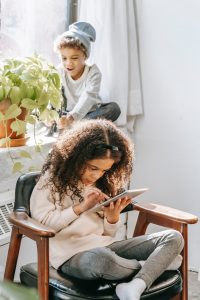 Kid-sitting-on-a-chair-and-using-a-phone