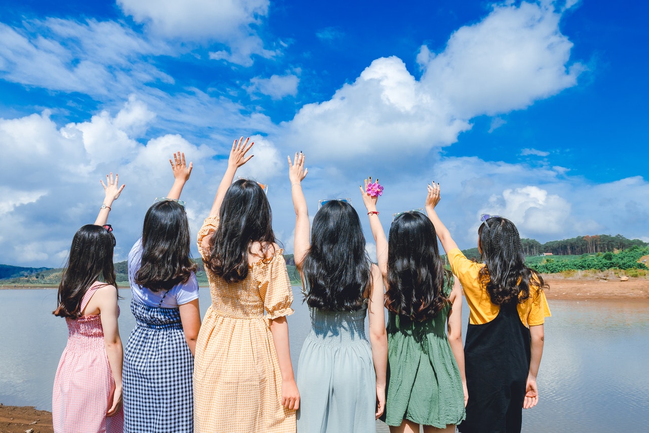 group of girls raising hand