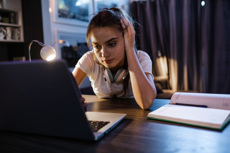 Teenage girl looking at a laptop
