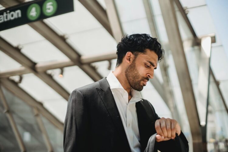 A man looking at a wrist watch